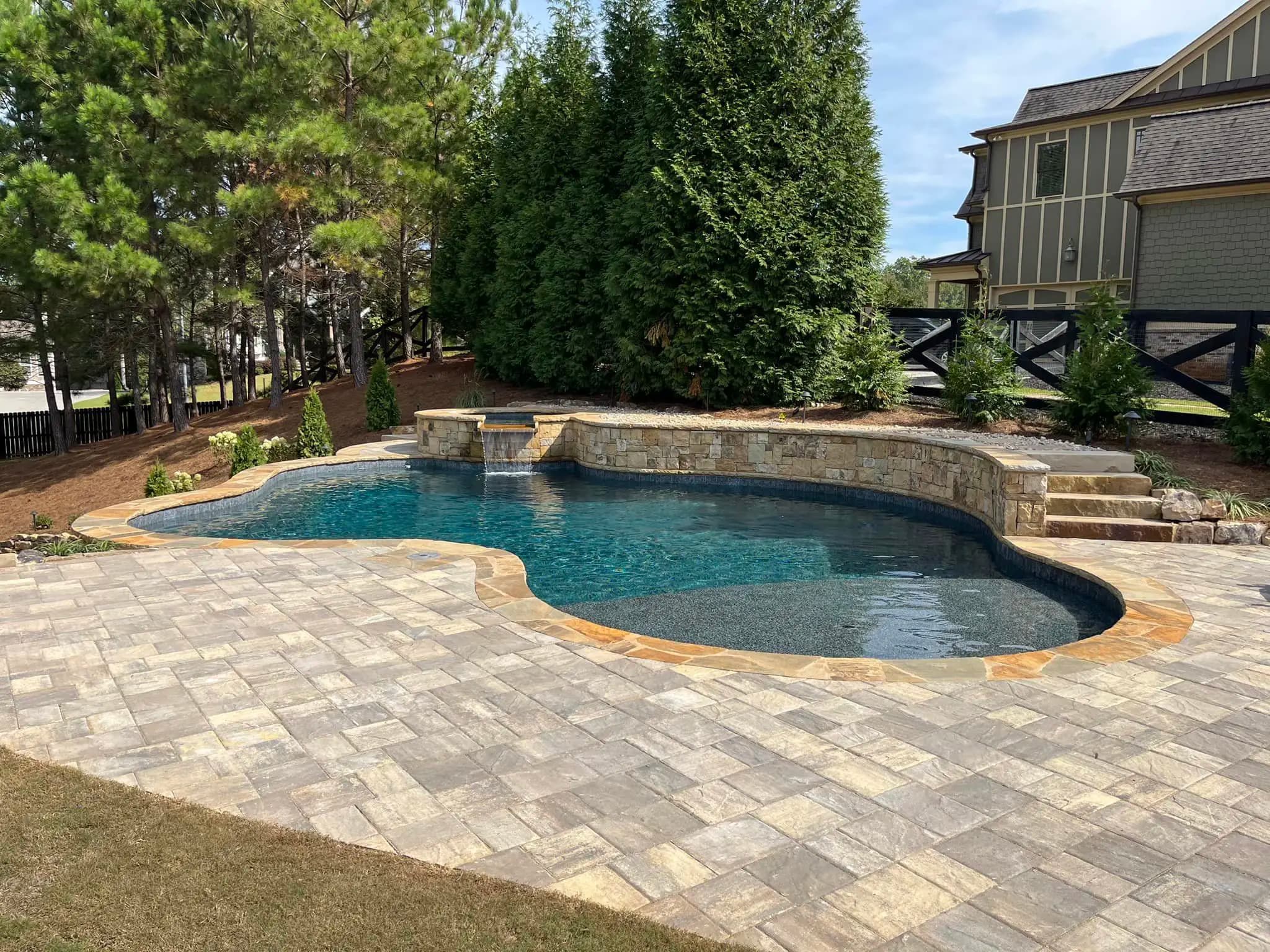 Custom gunite pool and outdoor living space built by Solid Rock in Northwest Metro Atlanta