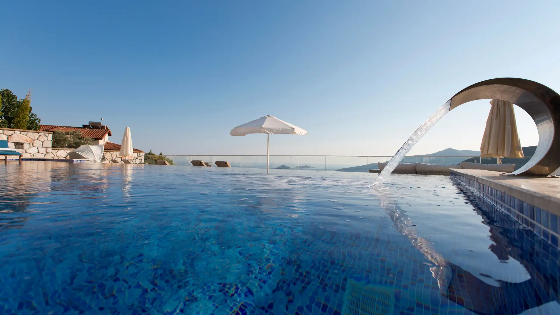 Straight-edged pool with a vanishing edge and tiled interior